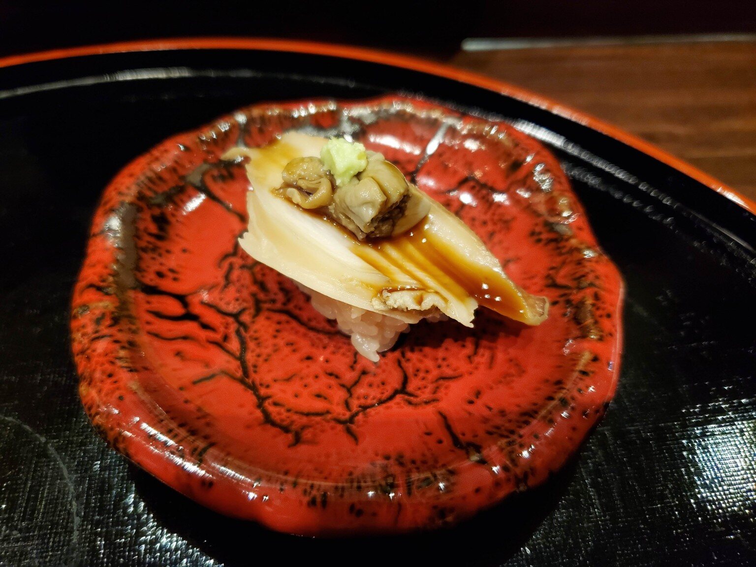 Shellfish nigiri finished with a savory glaze