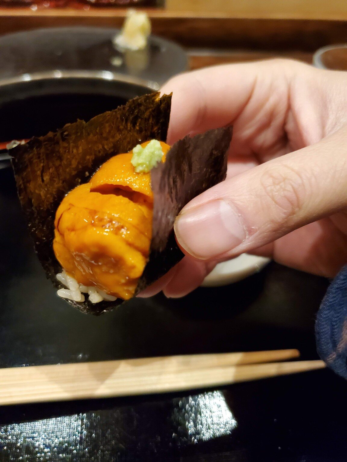 Uni hand roll served across the counter